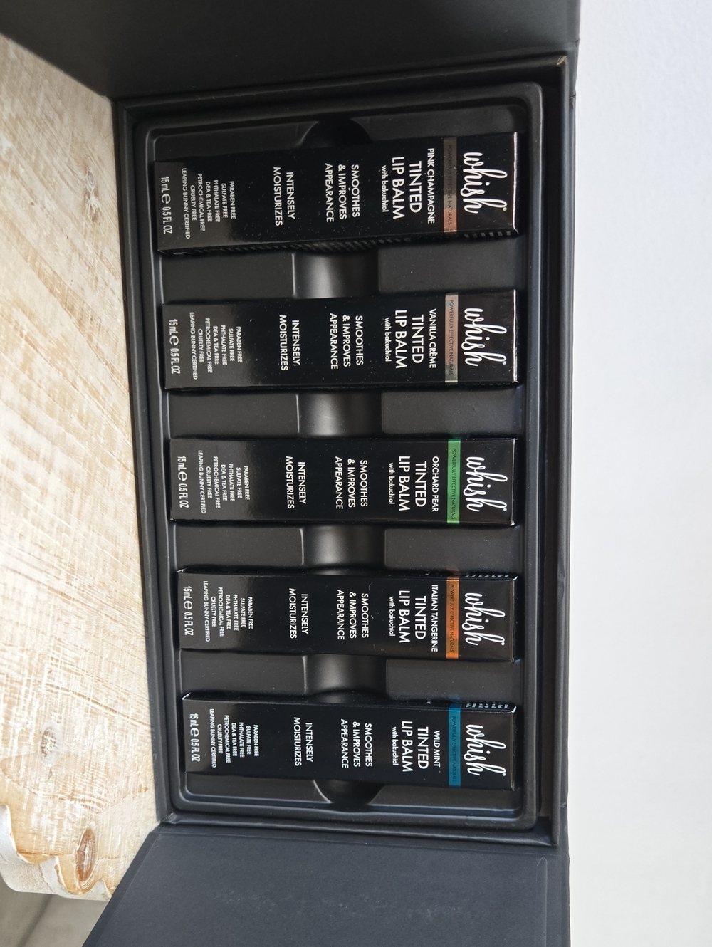 whish Tinted Lip Balm Set in Black Packaging with Green & Teal Accents